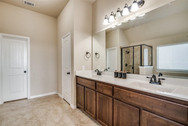 bathroom featuring vanity, walk in shower, and tile patterned floors