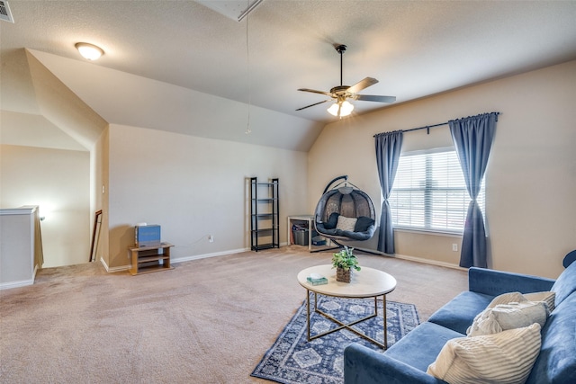 living room featuring lofted ceiling, a textured ceiling, light carpet, and ceiling fan