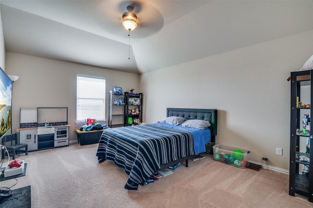 carpeted bedroom with lofted ceiling and ceiling fan