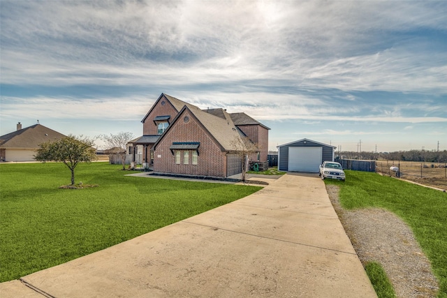 view of front of home featuring a garage, an outdoor structure, and a front lawn