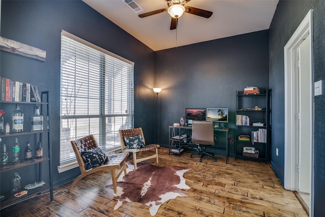 home office with ceiling fan and hardwood / wood-style flooring