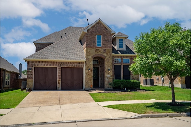 view of front of house featuring a garage, central air condition unit, and a front yard