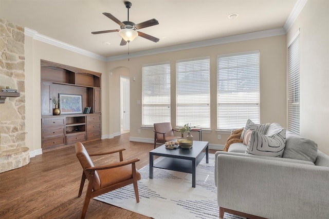 living room featuring ceiling fan, hardwood / wood-style floors, and ornamental molding