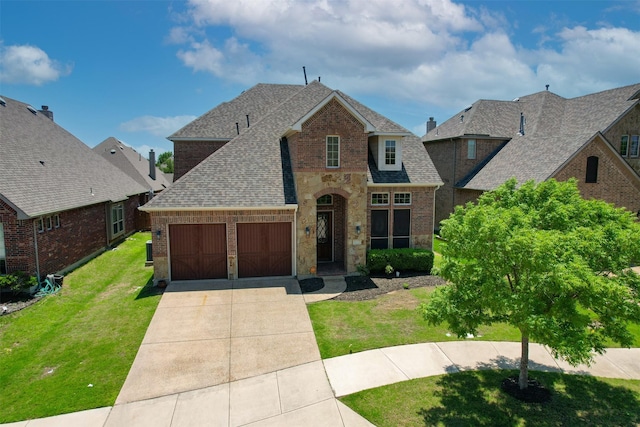 view of front of house with a front yard and a garage