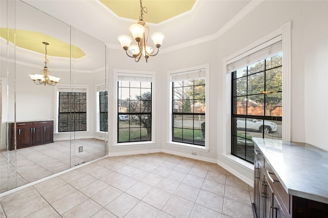 unfurnished dining area featuring a raised ceiling, a chandelier, light tile patterned floors, and crown molding