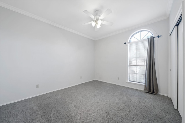 unfurnished room featuring ceiling fan, ornamental molding, and carpet