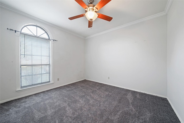 spare room with ceiling fan, crown molding, and dark colored carpet