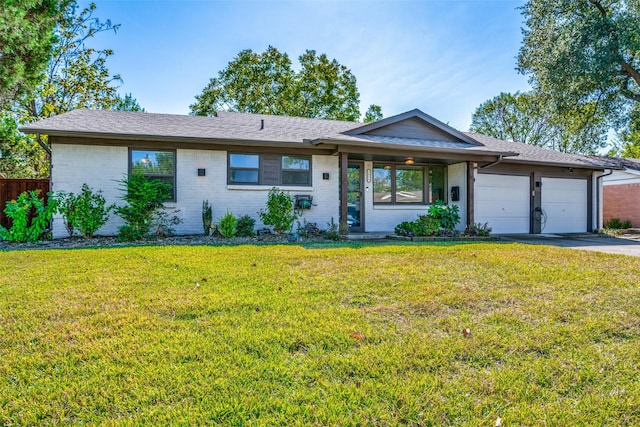 ranch-style house with a garage and a front lawn