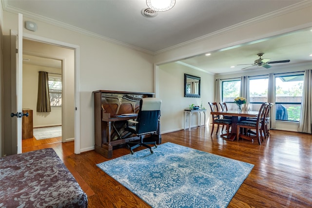 dining space with dark wood-type flooring, ceiling fan, and ornamental molding