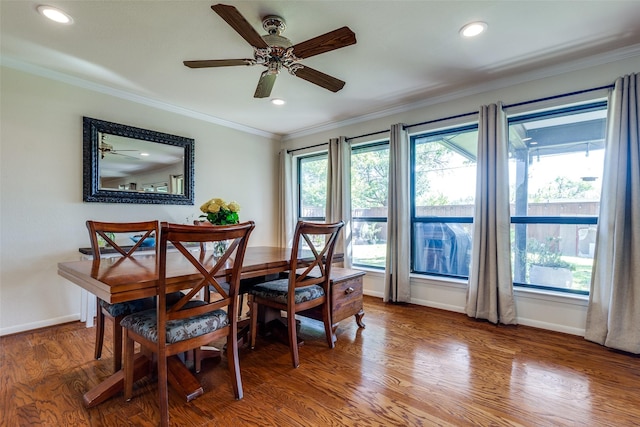 dining area featuring crown molding, wood-type flooring, and a wealth of natural light