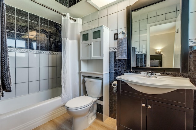 full bathroom featuring toilet, tile walls, backsplash, and shower / bath combo with shower curtain