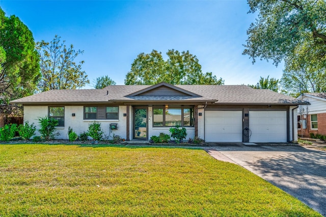 single story home featuring a garage and a front yard