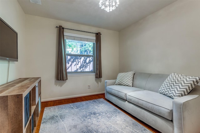 living room featuring dark hardwood / wood-style flooring and a chandelier