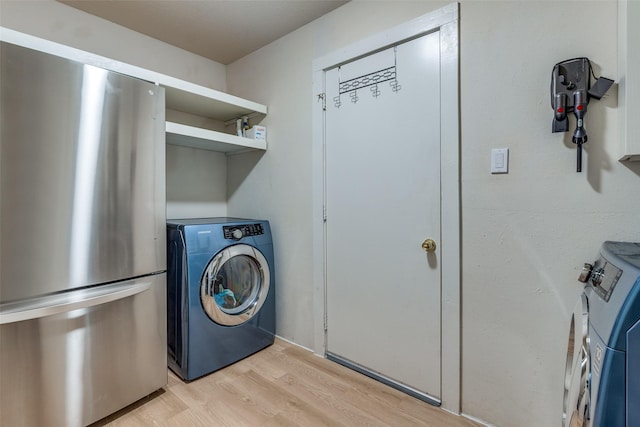 laundry room with light hardwood / wood-style floors and independent washer and dryer