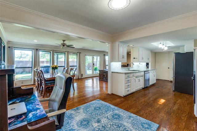 kitchen featuring dark wood-type flooring, sink, white cabinetry, appliances with stainless steel finishes, and light stone countertops