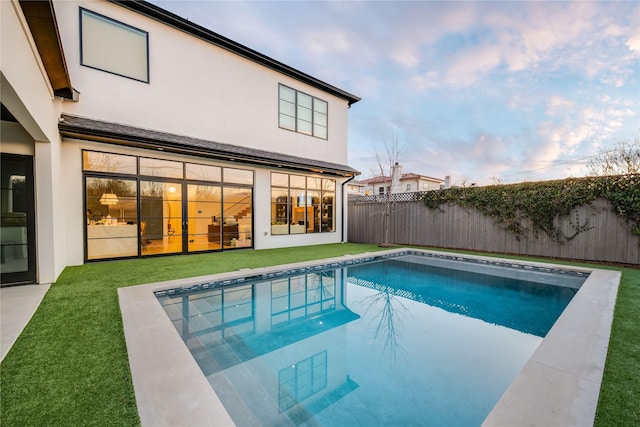 view of pool with a lawn