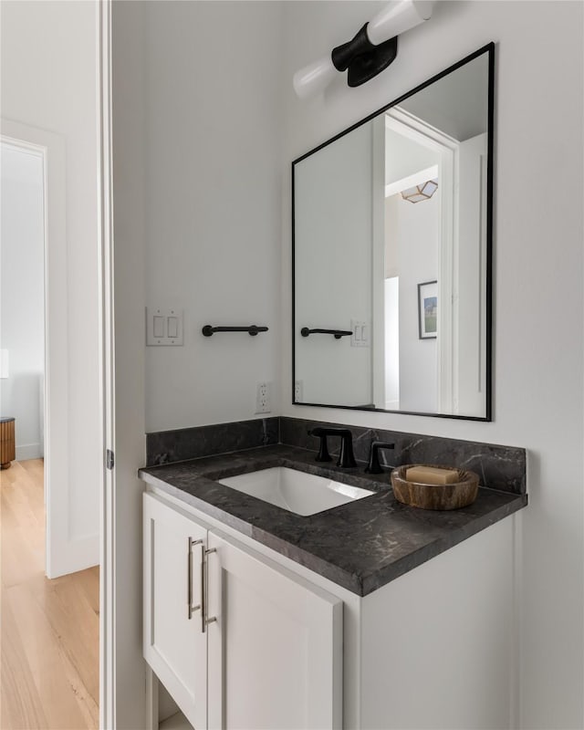 bathroom with hardwood / wood-style flooring and vanity