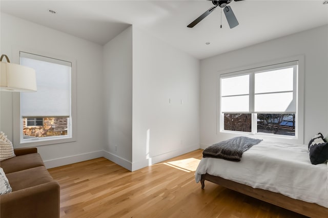 bedroom with ceiling fan and light hardwood / wood-style floors