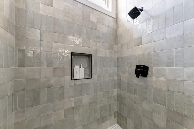 bathroom with a tile shower