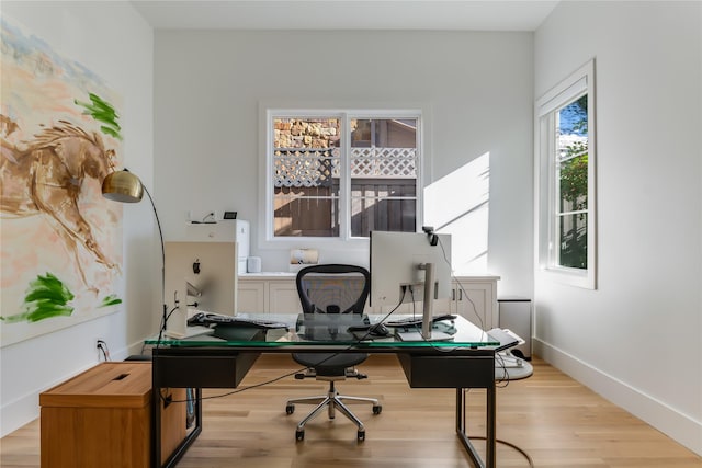 office area with light hardwood / wood-style floors