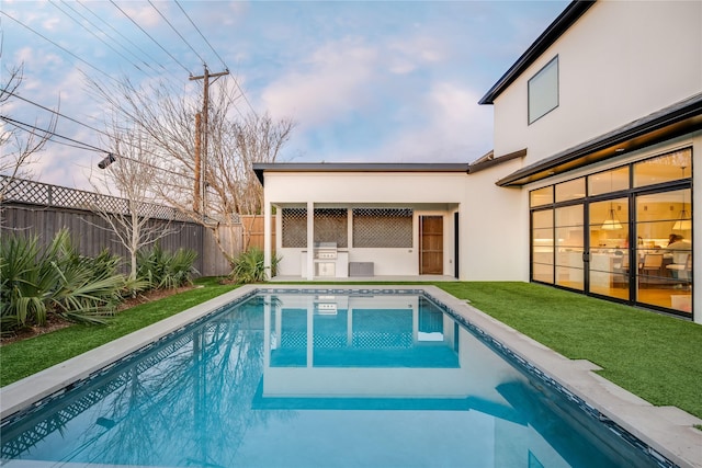 view of pool with a yard