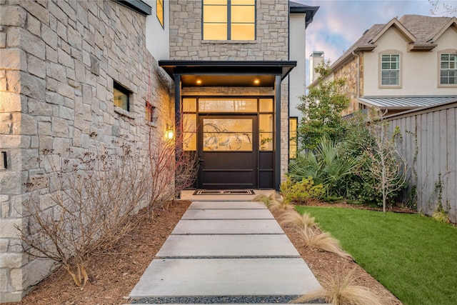 doorway to property featuring a yard