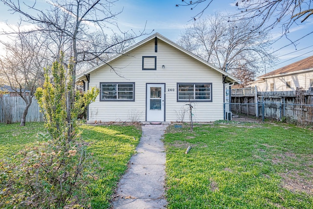 bungalow-style home featuring a front lawn