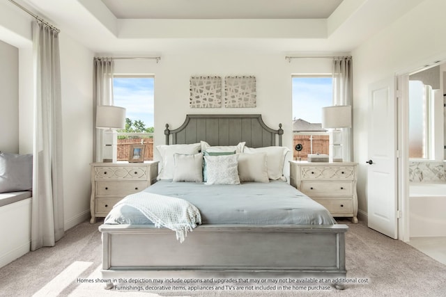 carpeted bedroom with multiple windows and a tray ceiling