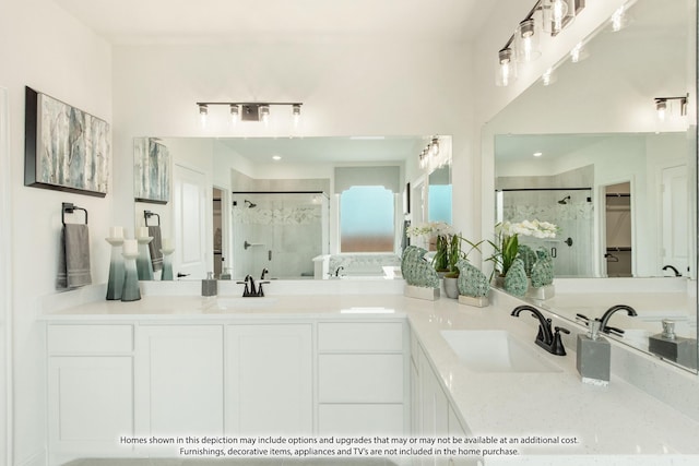 bathroom featuring vanity and a shower with shower door