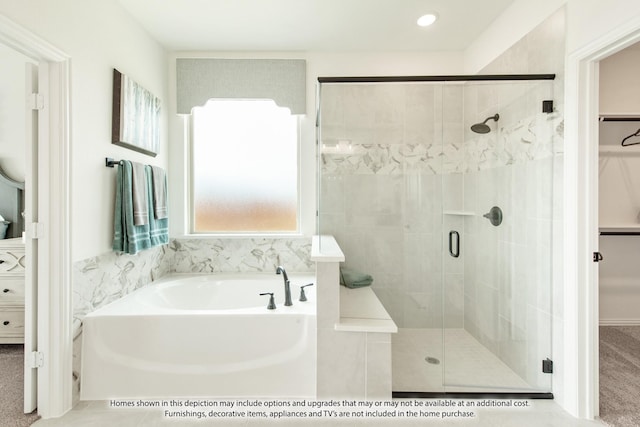 bathroom featuring separate shower and tub