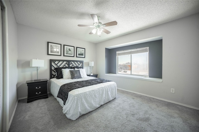 carpeted bedroom featuring a textured ceiling and ceiling fan