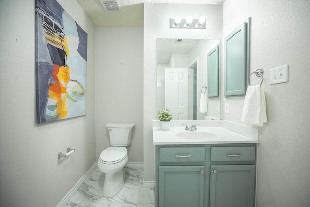 bathroom featuring toilet and vanity