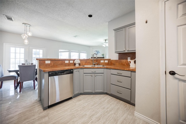 kitchen featuring kitchen peninsula, dishwasher, gray cabinets, ceiling fan, and sink