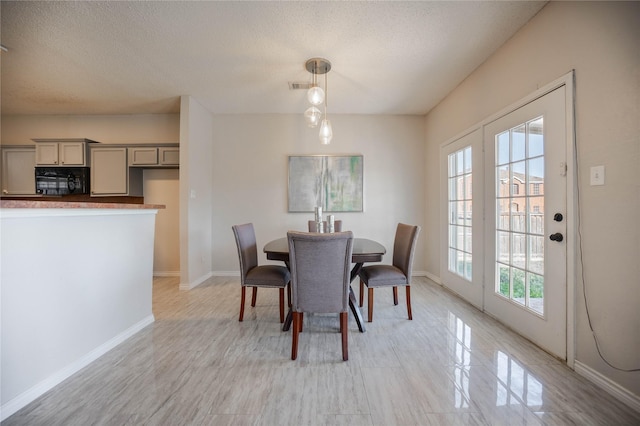 dining space featuring a textured ceiling