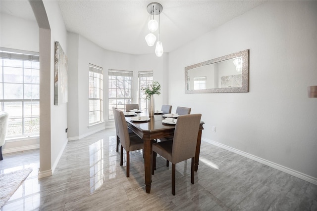 dining space with a textured ceiling