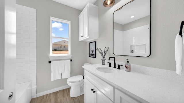 full bathroom featuring toilet, hardwood / wood-style floors, vanity, and shower / bathing tub combination