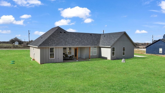 rear view of house featuring a patio area and a yard