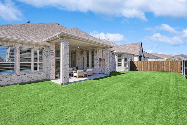 back of house featuring a yard and a patio