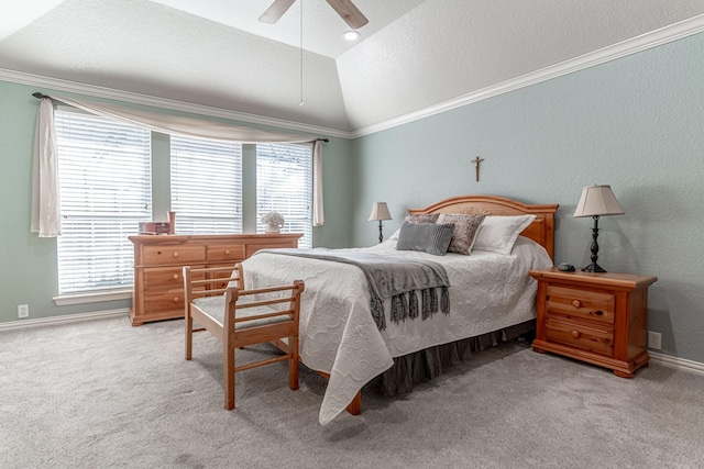 carpeted bedroom with a textured ceiling, a ceiling fan, baseboards, vaulted ceiling, and crown molding