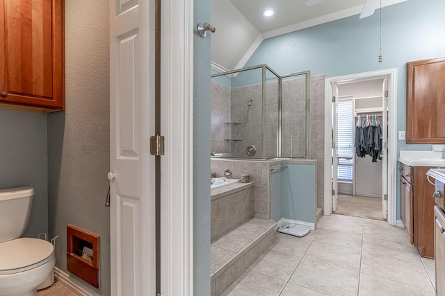 bathroom with toilet, vanity, tiled shower, a bath, and tile patterned floors