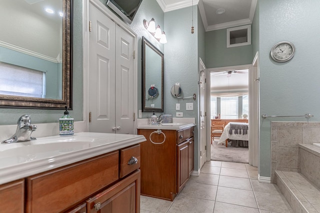 bathroom featuring connected bathroom, a sink, two vanities, ornamental molding, and tile patterned floors