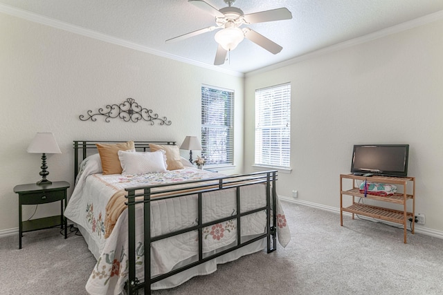 carpeted bedroom featuring baseboards, a textured ceiling, ornamental molding, and a ceiling fan