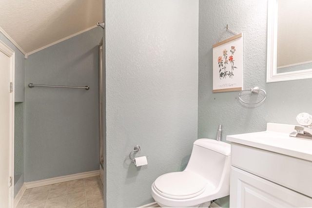 bathroom with a textured wall, toilet, tile patterned flooring, crown molding, and vanity