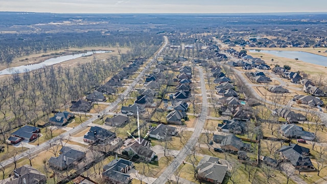 drone / aerial view featuring a water view and a residential view