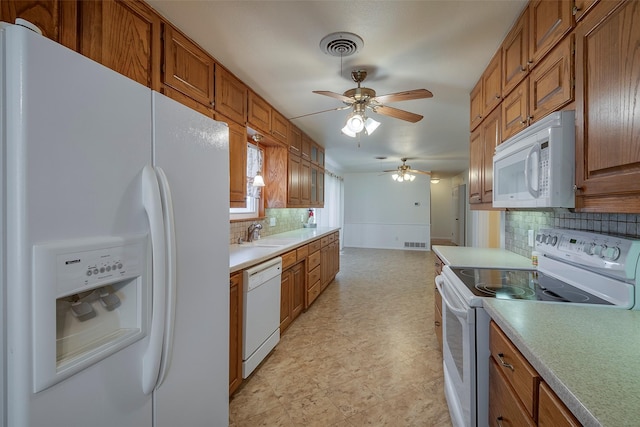 kitchen with ceiling fan, decorative backsplash, sink, and white appliances