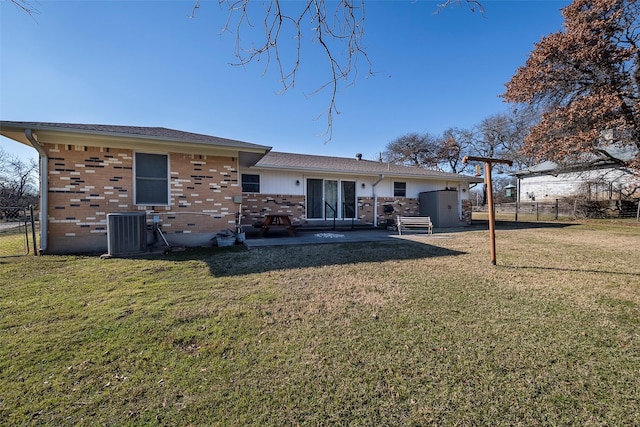 back of property featuring cooling unit and a yard