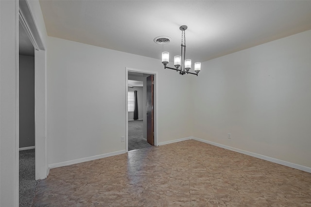 spare room with an inviting chandelier