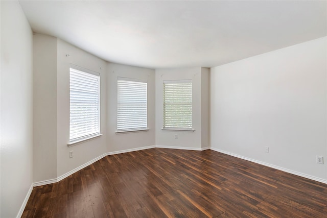 spare room featuring dark hardwood / wood-style floors