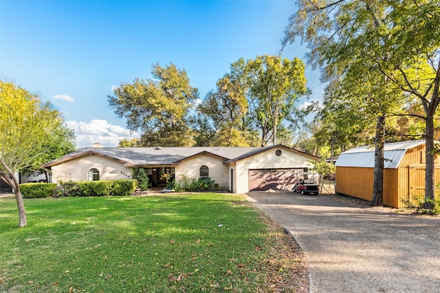 view of front of house with a front yard and a garage