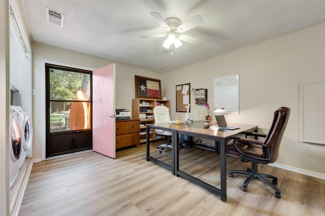 office area with ceiling fan, separate washer and dryer, light hardwood / wood-style floors, and a textured ceiling